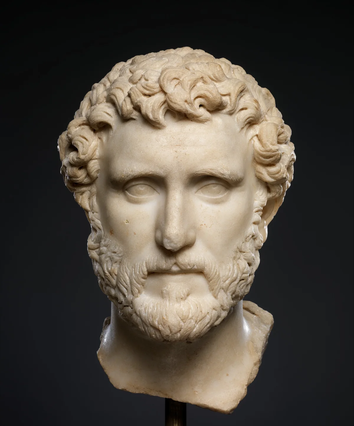 Marble portrait head of the emperor Antoninus Pius, bearded and calm, the stone clean and whole.