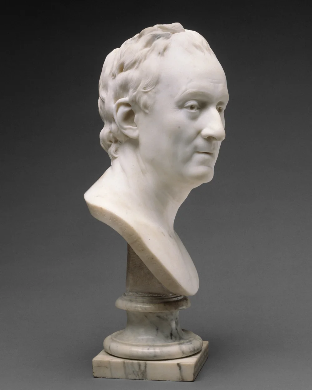 Jean Antoine Houdon's marble bust of the philosopher Denis Diderot, turned to one side, on its pedestal.